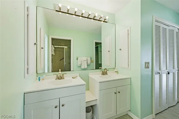 a bathroom with a double vanity sink mirror and next