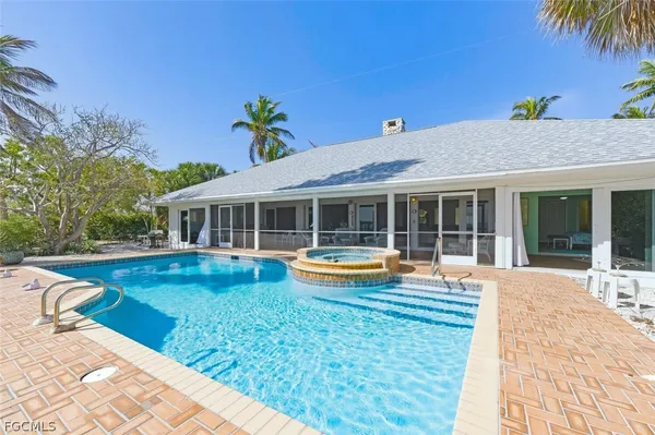 a view of a house with swimming pool and a yard