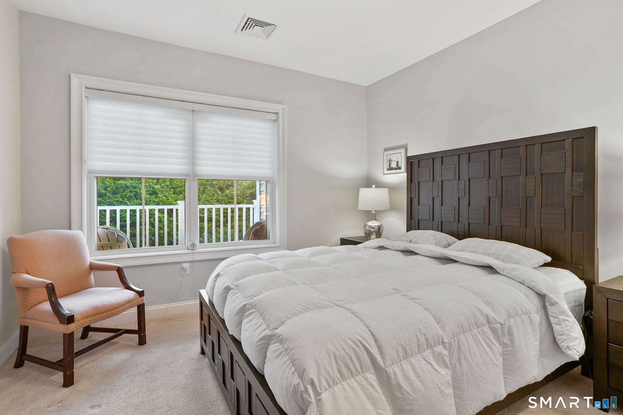 233 Danbury Road, Unit A209 Ridgefield, CT 06877 - Photo 11 of 25 a spacious bedroom with a bed and a chair