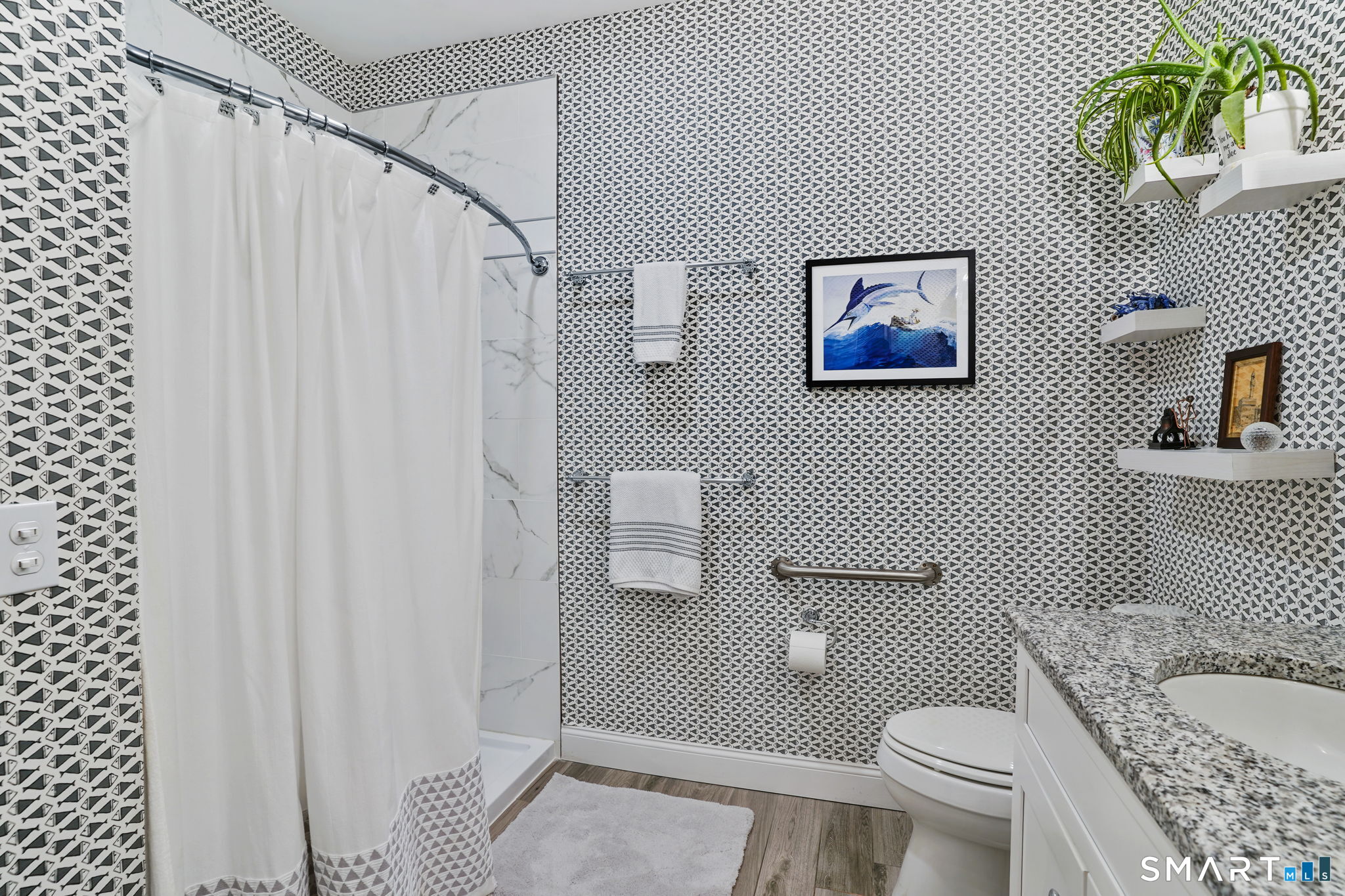 233 Danbury Road, Unit A209 Ridgefield, CT 06877 - Photo 13 of 25 a bathroom with a granite countertop toilet and a shower curtain