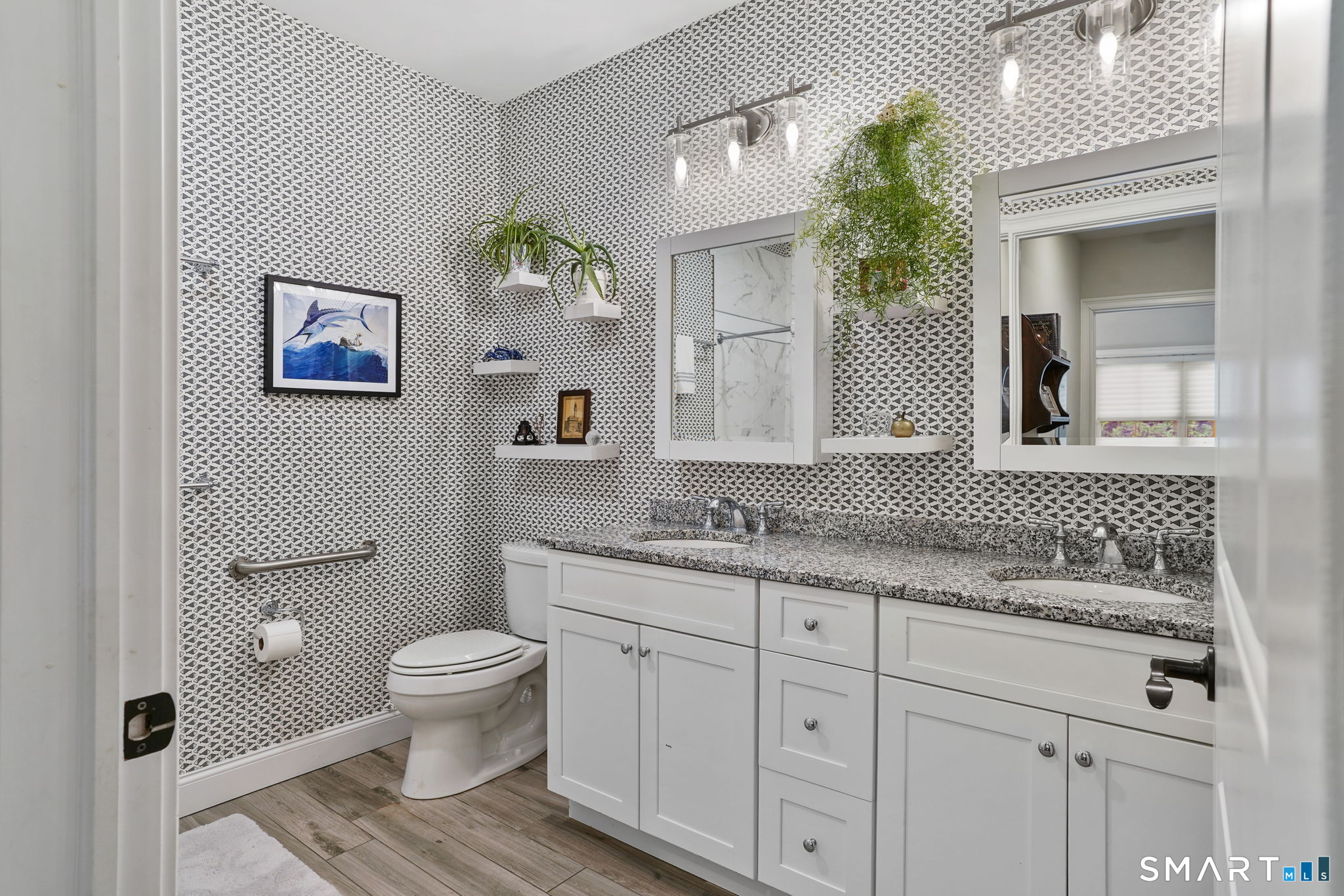 233 Danbury Road, Unit A209 Ridgefield, CT 06877 - Photo 14 of 25 a bathroom with a granite countertop toilet a sink and a mirror