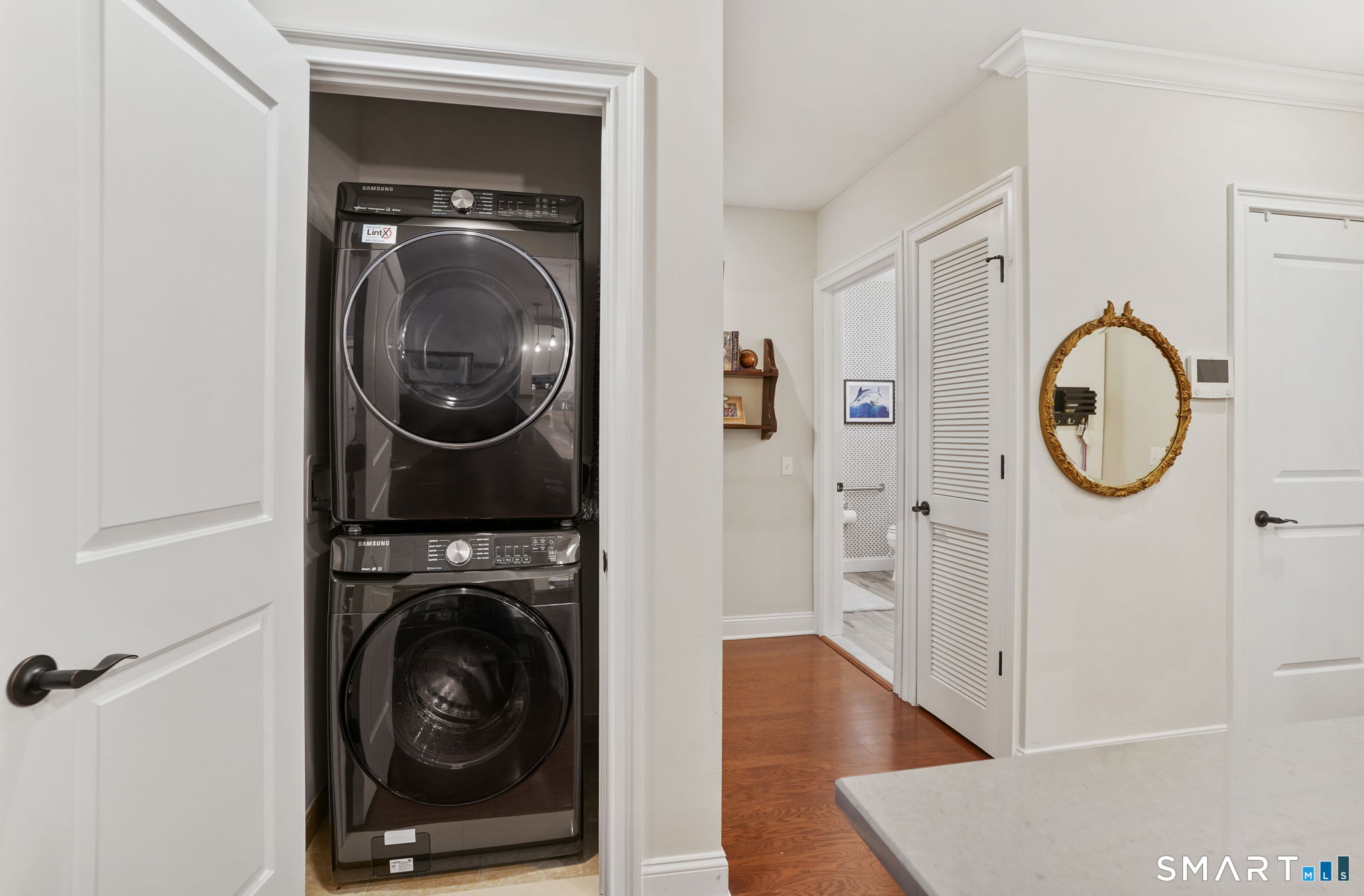 233 Danbury Road, Unit A209 Ridgefield, CT 06877 - Photo 19 of 25 a view of a hallway with washer and dryer