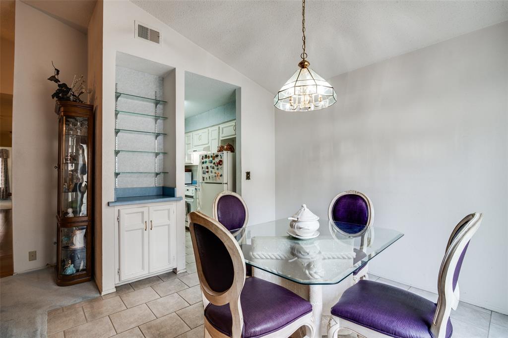 1916 Cobblestone Lane Garland, TX 75042 - Photo 15 of 33 Dining space with a chandelier, light tile patterned flooring, and lofted ceiling