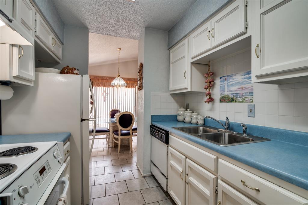 1916 Cobblestone Lane Garland, TX 75042 - Photo 17 of 33 Kitchen featuring dishwasher, a textured ceiling, a sink, backsplash, and a chandelier