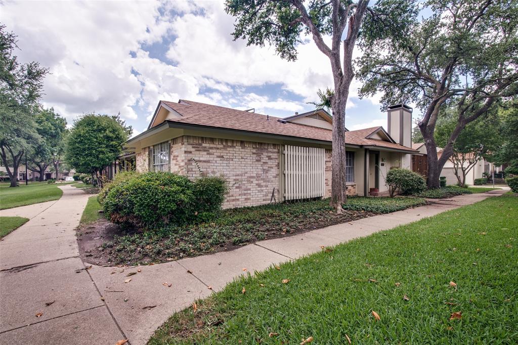 1916 Cobblestone Lane Garland, TX 75042 - Photo 2 of 33 View of home's exterior featuring a lawn, brick siding, a chimney, and a shingled roof