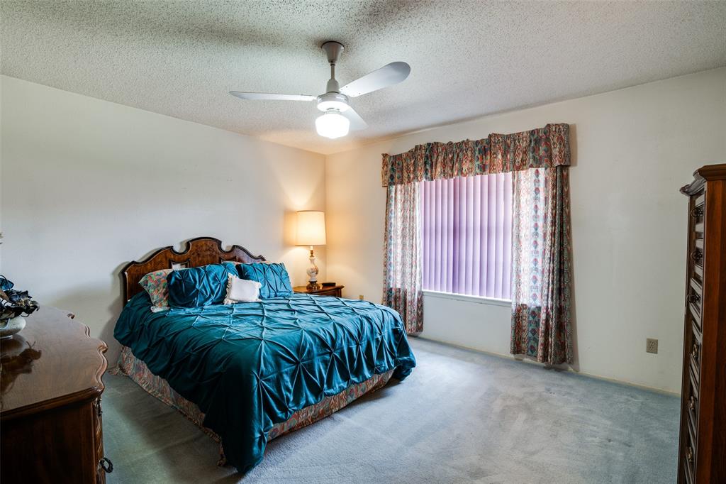 1916 Cobblestone Lane Garland, TX 75042 - Photo 22 of 33 Bedroom featuring carpet floors, a textured ceiling, and ceiling fan