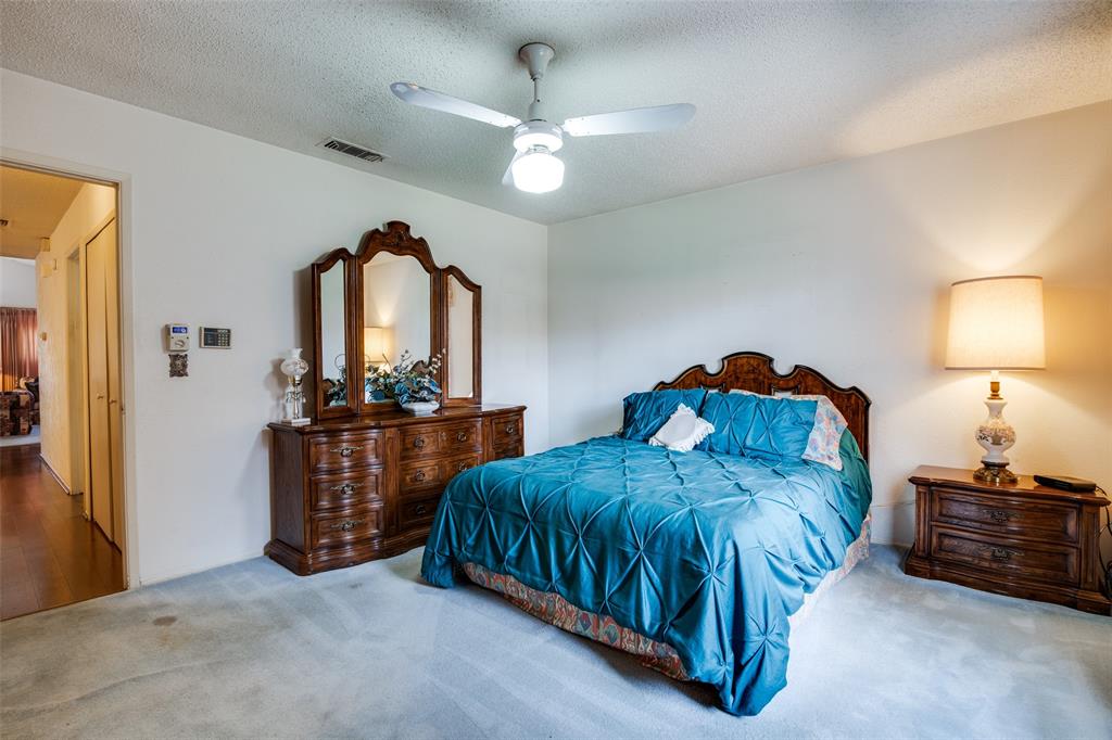 1916 Cobblestone Lane Garland, TX 75042 - Photo 23 of 33 Bedroom featuring carpet, ceiling fan, and a textured ceiling