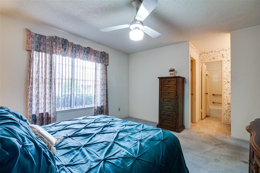 1916 Cobblestone Lane Garland, TX 75042 - Photo 25 of 33 Carpeted bedroom featuring a textured ceiling, a ceiling fan, and ensuite bathroom