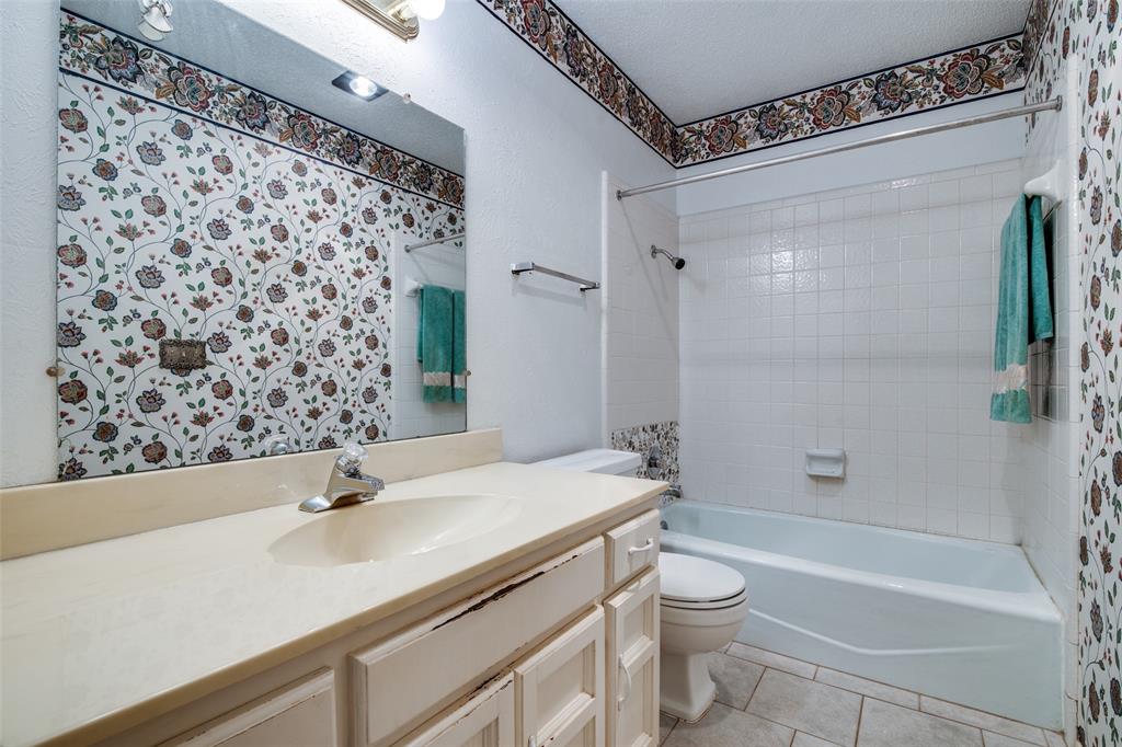 1916 Cobblestone Lane Garland, TX 75042 - Photo 29 of 33 Bathroom featuring toilet, vanity, bathing tub / shower combination, and tile patterned flooring