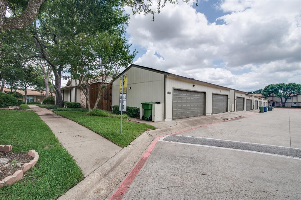 1916 Cobblestone Lane Garland, TX 75042 - Photo 4 of 33 View of home's exterior with community garages and a yard