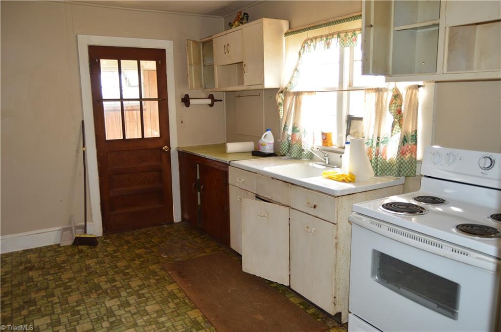 8600 Fulp Road Stokesdale, NC 27357 - Photo 19 of 30 Kitchen view to back door (enclosed porch) area