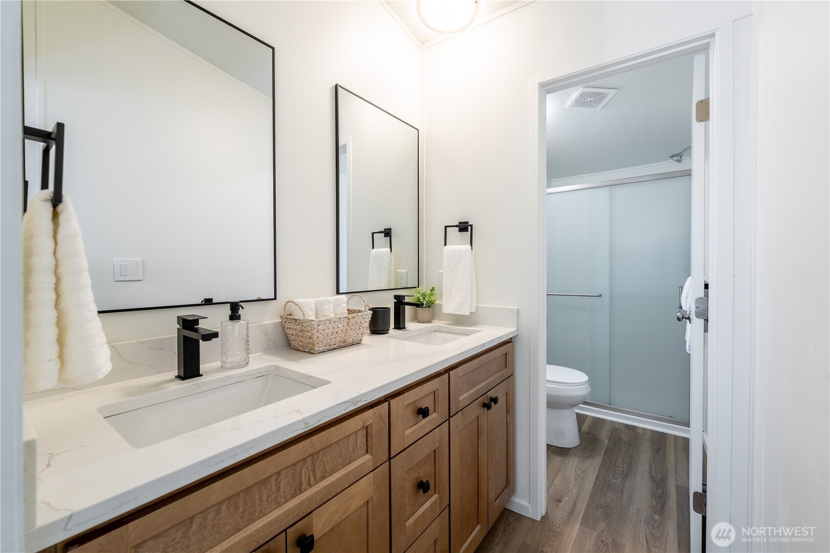 3408 Old Highway 99 North Road Burlington, WA 98233 - Photo 17 of 38 a bathroom with a double vanity sink toilet and mirror