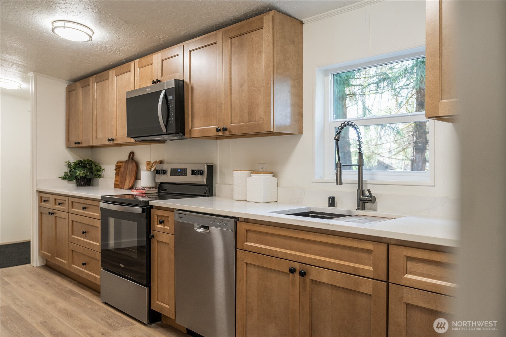 3408 Old Highway 99 North Road Burlington, WA 98233 - Photo 6 of 38 a kitchen with stainless steel appliances granite countertop white cabinets a stove a sink and a microwave
