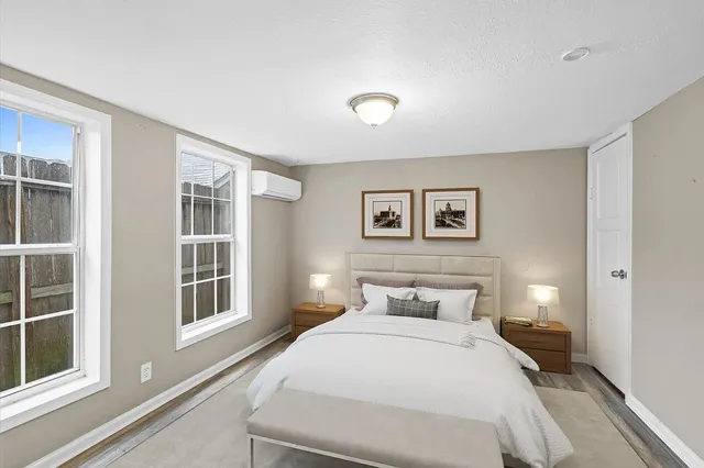 a bedroom with a large bed and a window