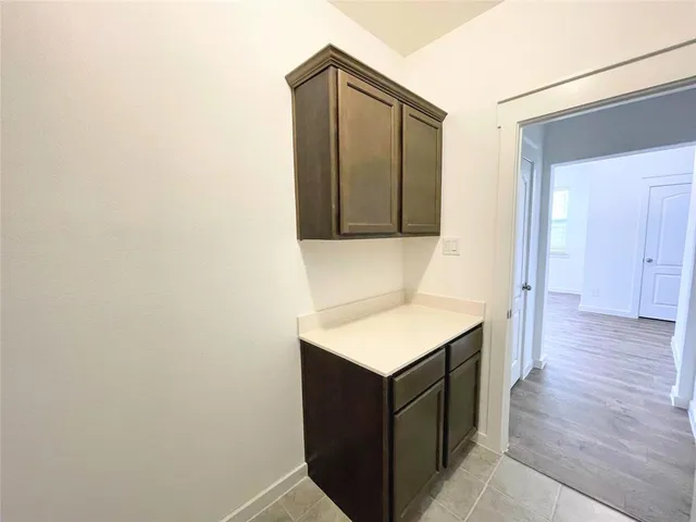 a kitchen with a sink a refrigerator and wooden floor