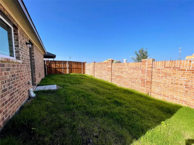 a view of yard with swimming pool and green space
