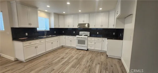 a kitchen with a sink a microwave and cabinets