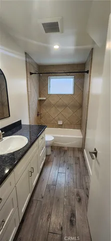 a bathroom with a sink a toilet and vanity