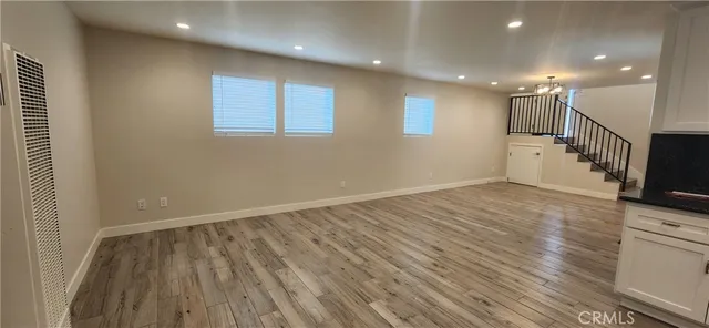 a view of a room with wooden floor