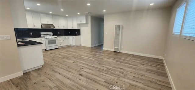 an open kitchen with kitchen island and stainless steel appliances