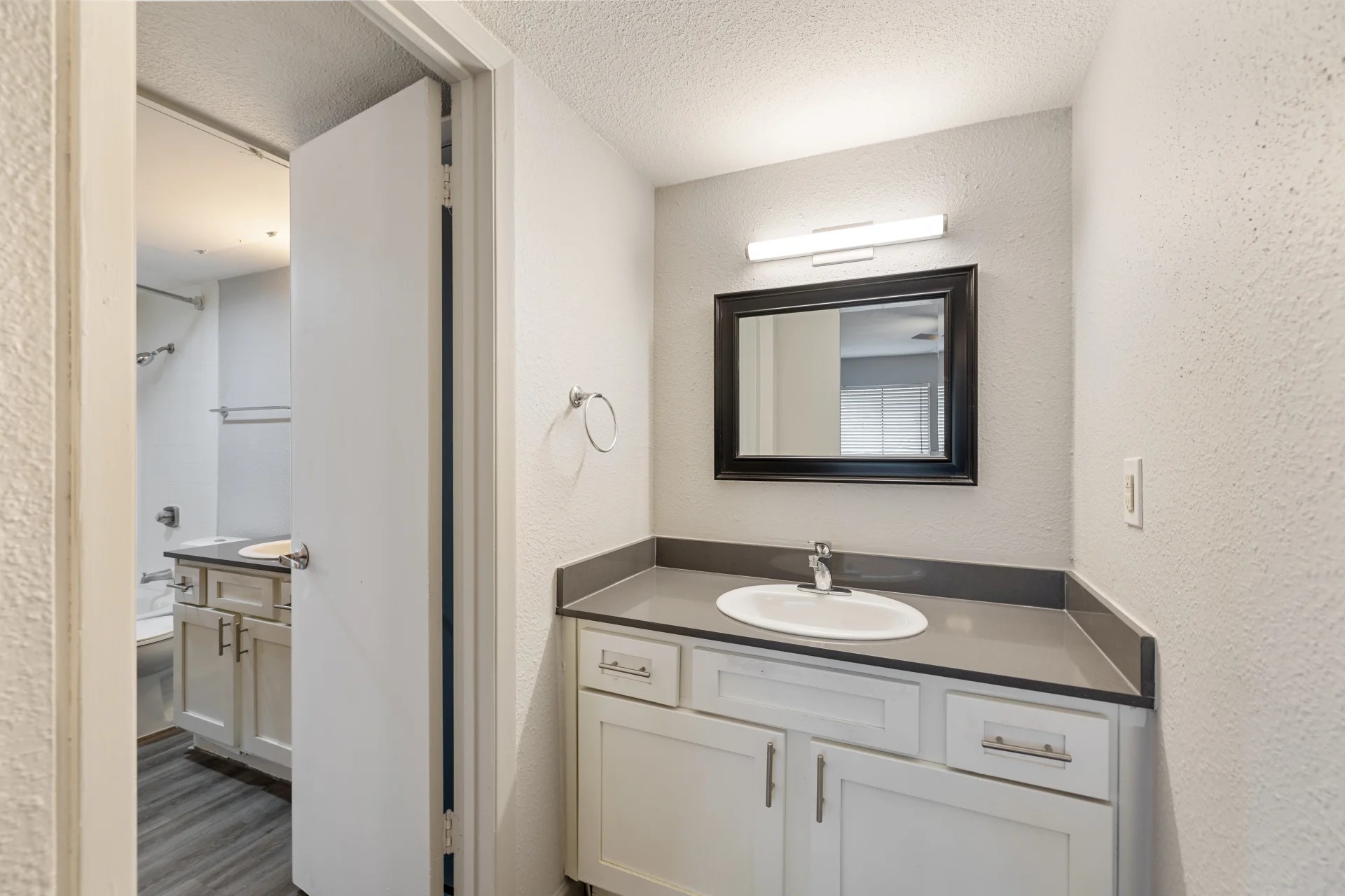 8701 Town Park Drive, Unit 483202 Houston, TX 77036 - Photo 7 of 20 a bathroom with a toilet sink and mirror