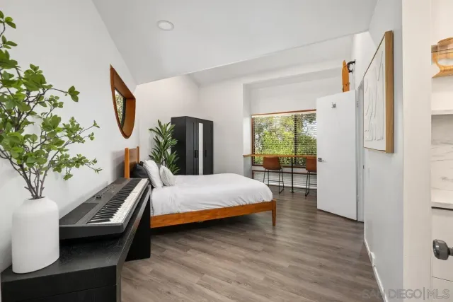 a bedroom with a bed and a potted plant