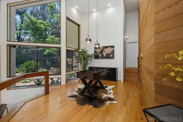 a living room with furniture and a floor to ceiling window