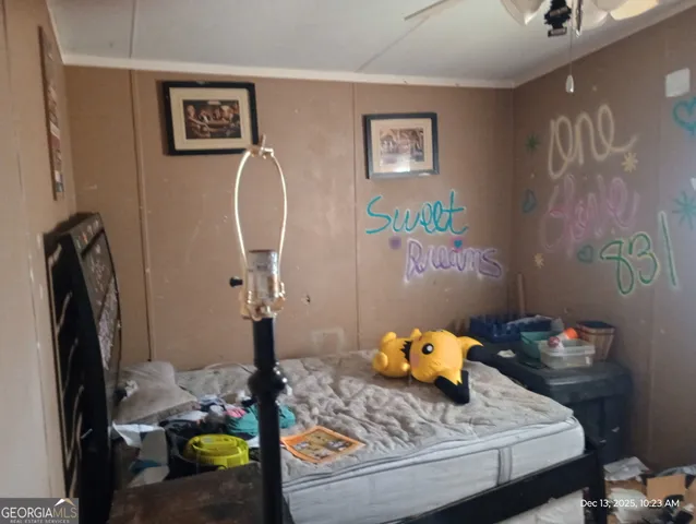 a bed room with furniture and next to a window