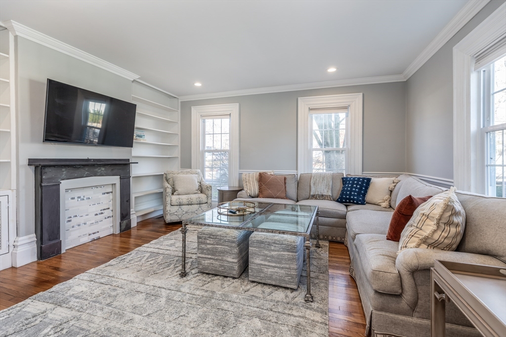 a living room with furniture a flat screen tv and a fireplace