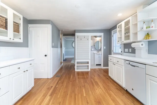 a view of a kitchen with wooden floor and electronic appliances