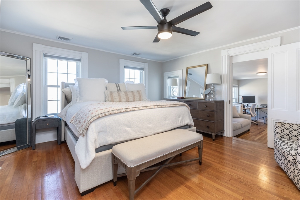 1076 Adams Street Boston, MA 02124 - Photo 15 of 29 a bedroom with a bed and wooden floor