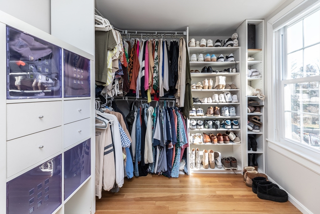 1076 Adams Street Boston, MA 02124 - Photo 21 of 29 a view of walk in closet with clothes and shoes