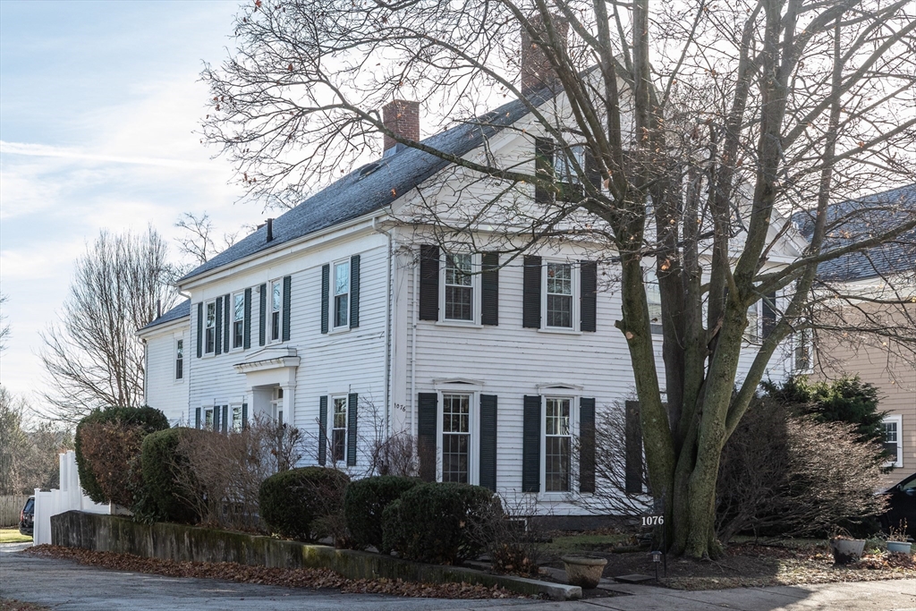 1076 Adams Street Boston, MA 02124 - Photo 29 of 29 a front view of a house with garden trees and plants