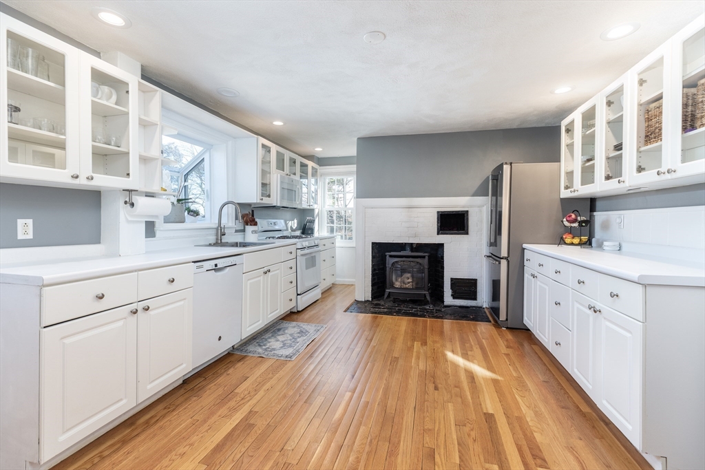 1076 Adams Street Boston, MA 02124 - Photo 10 of 29 a kitchen with cabinets and wooden floor