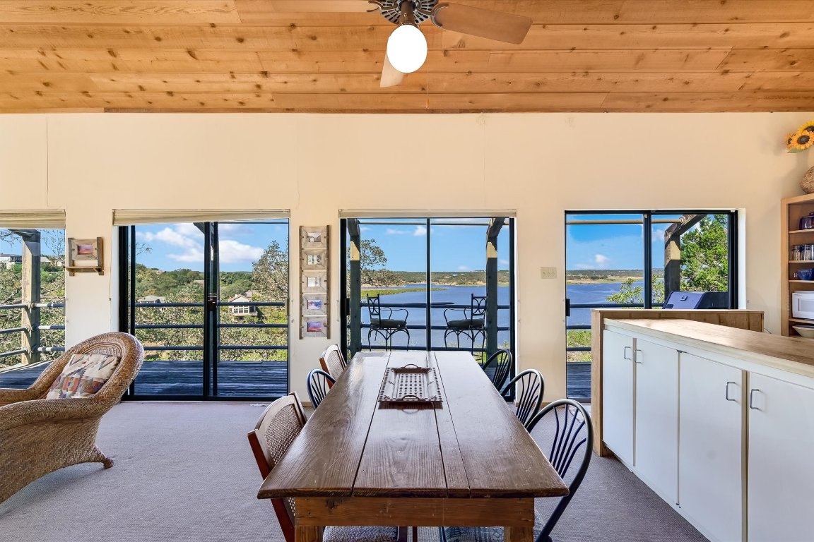 501 Coventry Road Spicewood, TX 78669 - Photo 11 of 24 a view of a dining room with furniture wooden floor and a large window