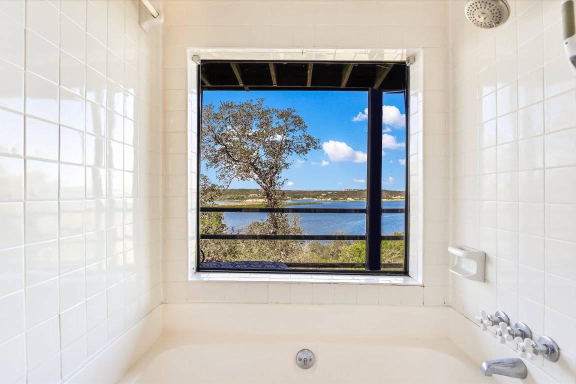 501 Coventry Road Spicewood, TX 78669 - Photo 16 of 24 a bathroom with a bathtub and a shower