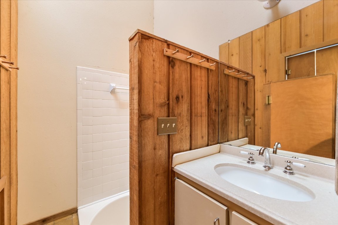 501 Coventry Road Spicewood, TX 78669 - Photo 22 of 24 a bathroom with a sink and a mirror