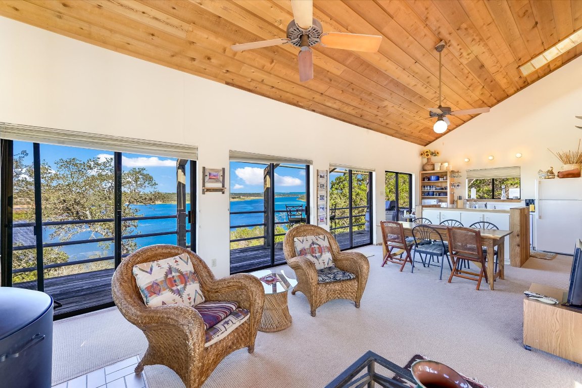 501 Coventry Road Spicewood, TX 78669 - Photo 4 of 24 a living room with furniture floor to ceiling windows and a table