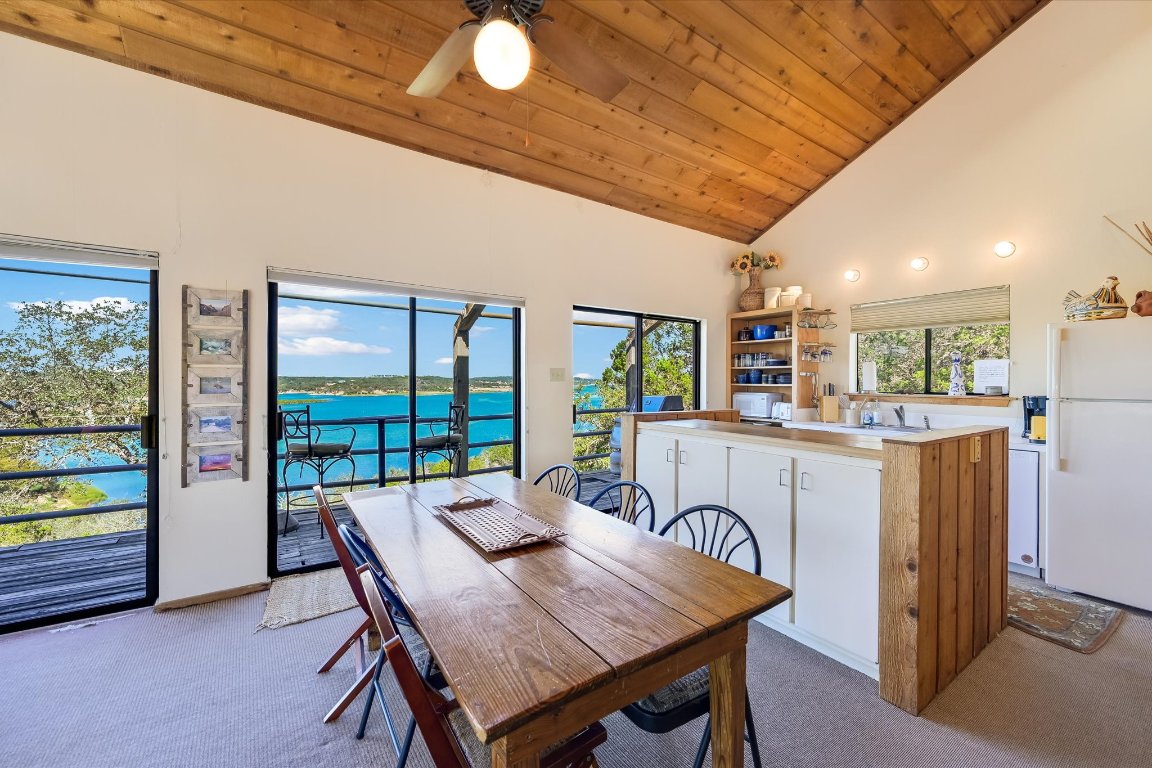 501 Coventry Road Spicewood, TX 78669 - Photo 5 of 24 a dining room with furniture and a floor to ceiling window