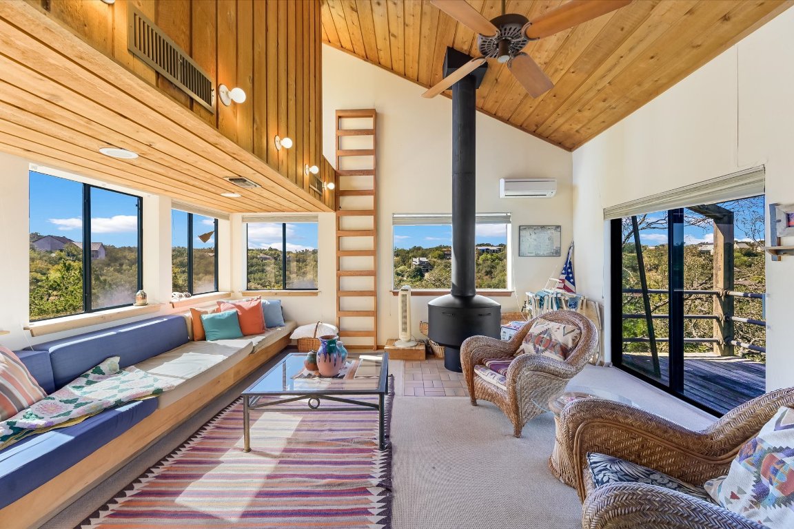 501 Coventry Road Spicewood, TX 78669 - Photo 7 of 24 a living room with furniture and floor to ceiling windows