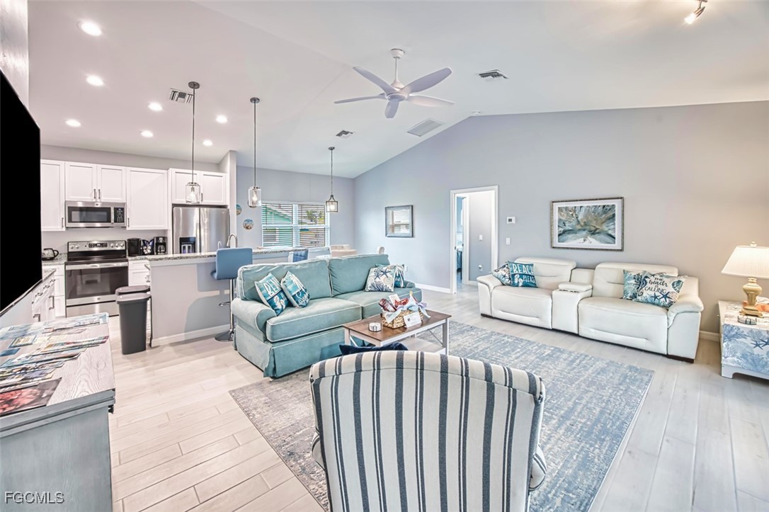 431 Lazy Way Fort Myers Beach, FL 33931 - Photo 14 of 40 a living room with furniture and a wooden floor
