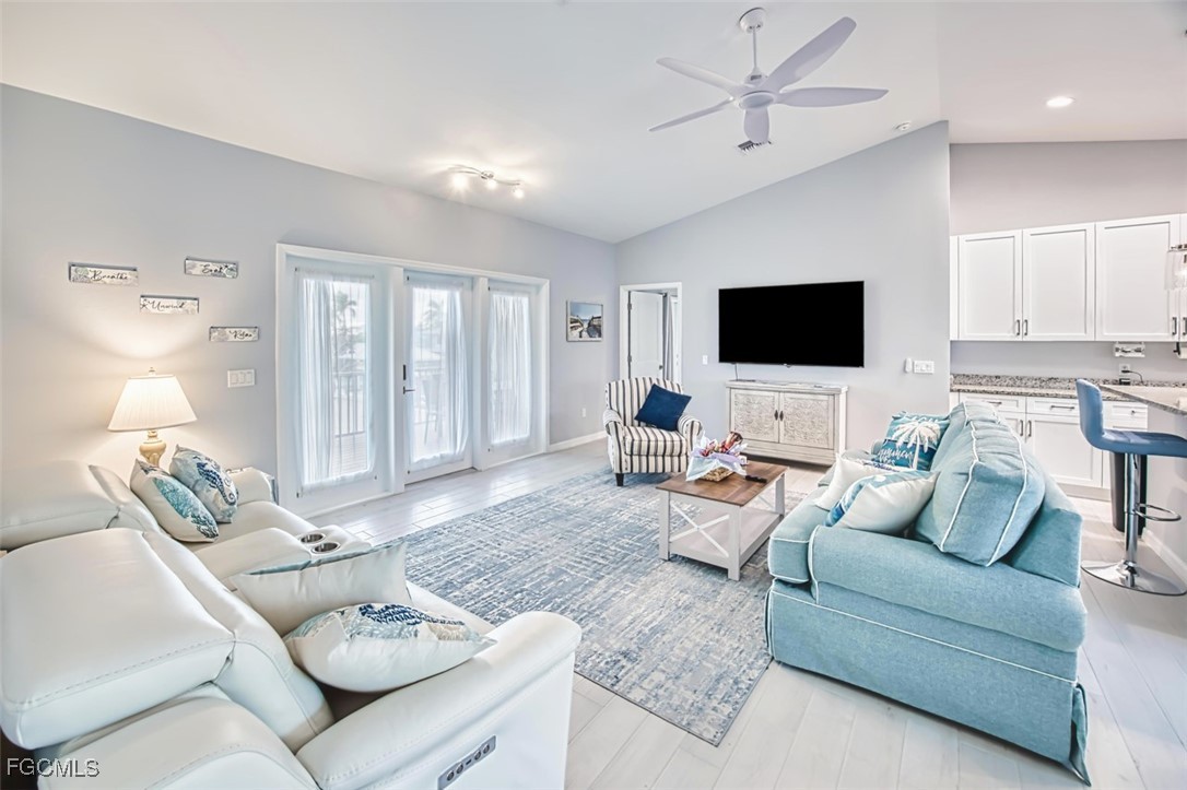 431 Lazy Way Fort Myers Beach, FL 33931 - Photo 15 of 40 a living room with furniture and a flat screen tv