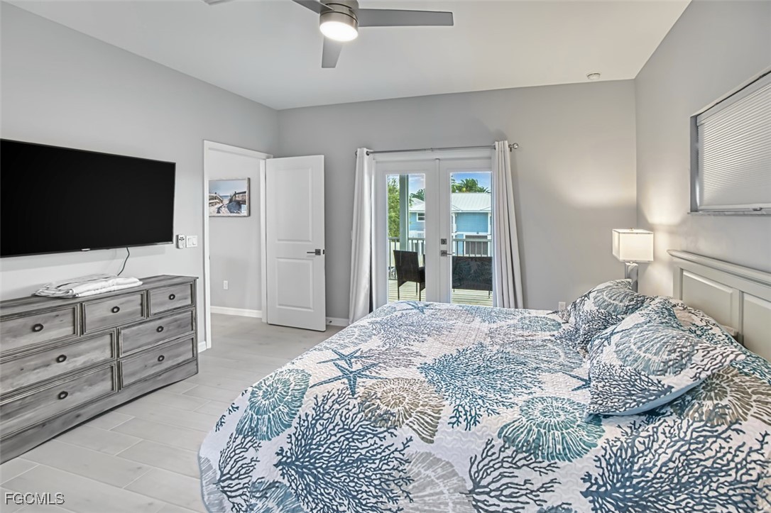 431 Lazy Way Fort Myers Beach, FL 33931 - Photo 28 of 40 a bedroom with a bed and a flat screen tv