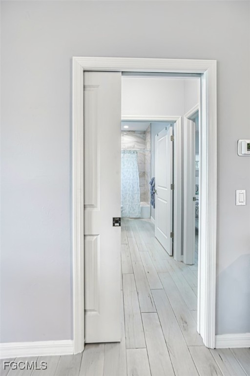 431 Lazy Way Fort Myers Beach, FL 33931 - Photo 29 of 40 a view of a hallway with wooden floor and a bathroom