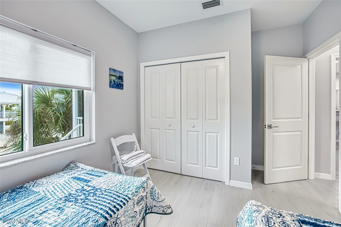 431 Lazy Way Fort Myers Beach, FL 33931 - Photo 32 of 40 a bedroom with a bed and a window