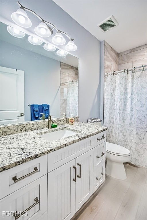 431 Lazy Way Fort Myers Beach, FL 33931 - Photo 34 of 40 a bathroom with a granite countertop sink a toilet and a large mirror