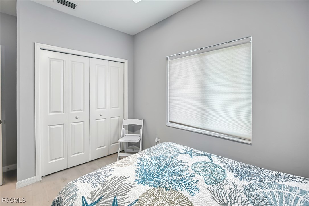 431 Lazy Way Fort Myers Beach, FL 33931 - Photo 36 of 40 a bedroom with a bed and a window