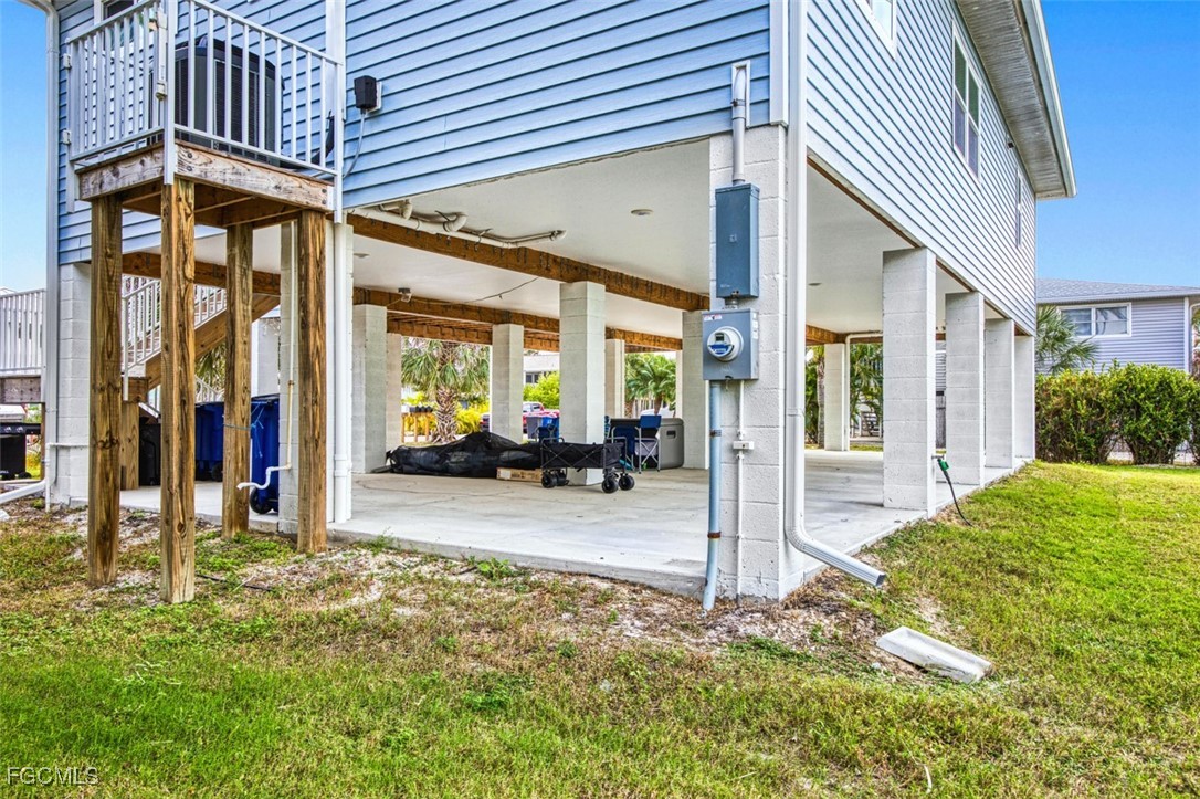 431 Lazy Way Fort Myers Beach, FL 33931 - Photo 39 of 40 a view of a patio with table and chairs and floor to ceiling window