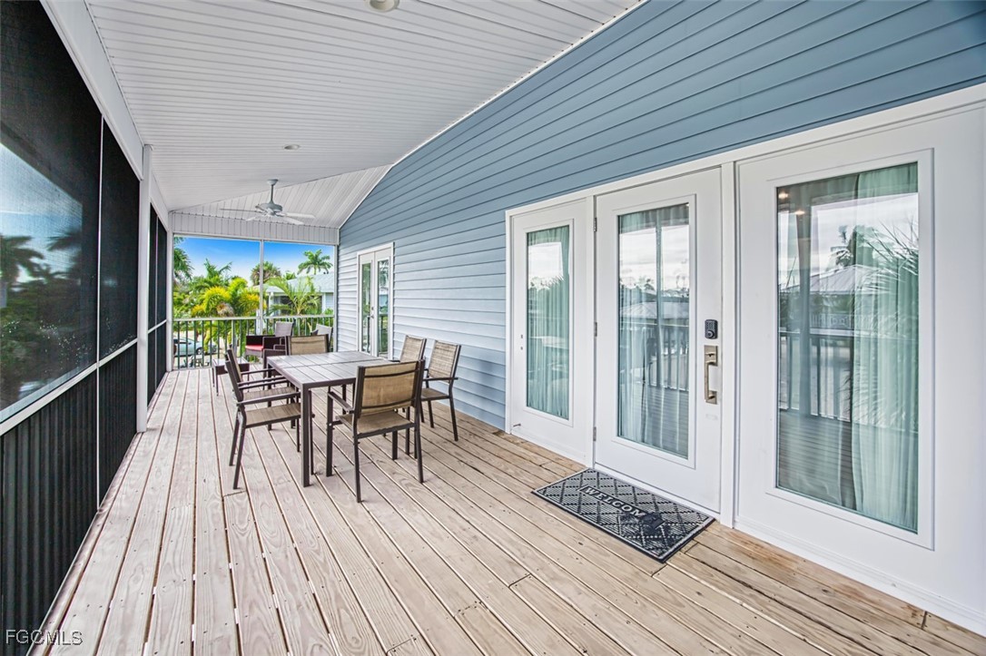431 Lazy Way Fort Myers Beach, FL 33931 - Photo 10 of 40 a view of a patio with table and chairs and wooden floor