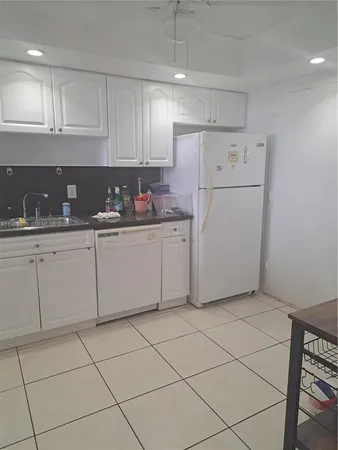 a kitchen with cabinets and white appliances